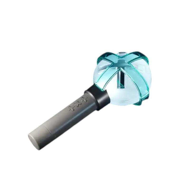 Lightstick Shop TXT Official Lightstick Ver.2 with a translucent orb and teal cross design, grey handle with TXT logo.
