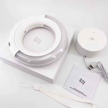 Lightstick Shop official ITZY light ring with white circular design, charging base, USB cable, and manual in box