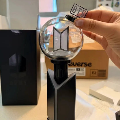 Lightstick Shop protective base cover for BTS ARMY Bomb Ver.4 lightstick in black, displayed on a desk.