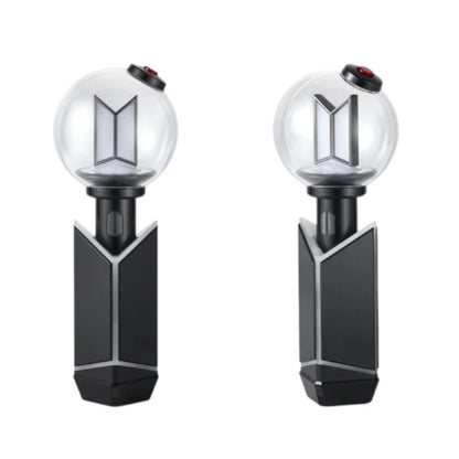 Lightstick Shop BTS ARMY Bomb Ver.4 black ABS charging cradle holding an official lightstick on a white background.