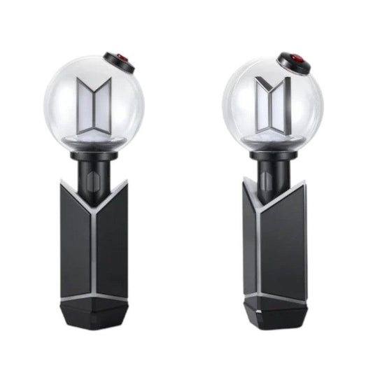Lightstick Shop BTS ARMY Bomb Ver.4 black ABS charging cradle holding an official lightstick on a white background.