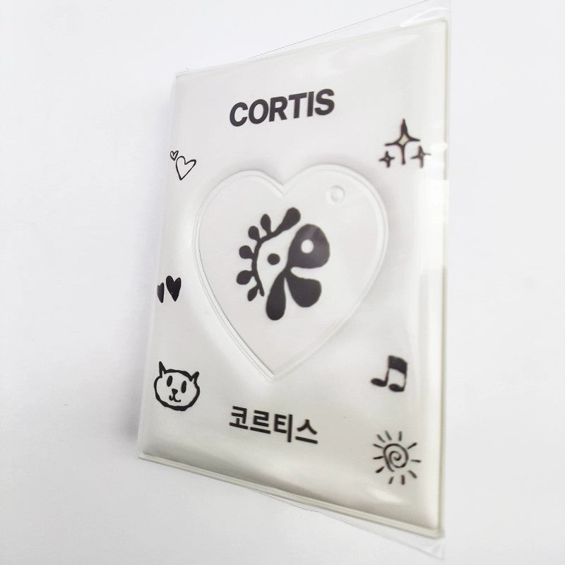 CORTIS album card holder with a heart-shaped window and black doodle graphics on clear plastic