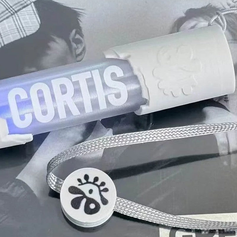 CORTIS mini LED lightstick keychain with white handle, clear tube, and lanyard strap