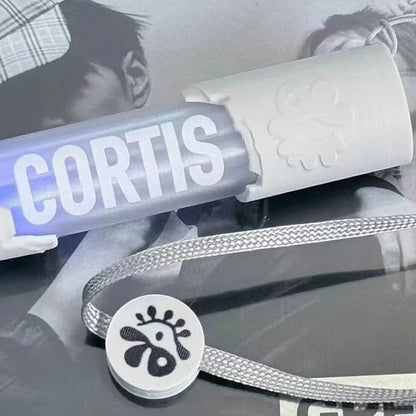 CORTIS mini LED lightstick keychain with white handle, clear tube, and lanyard strap