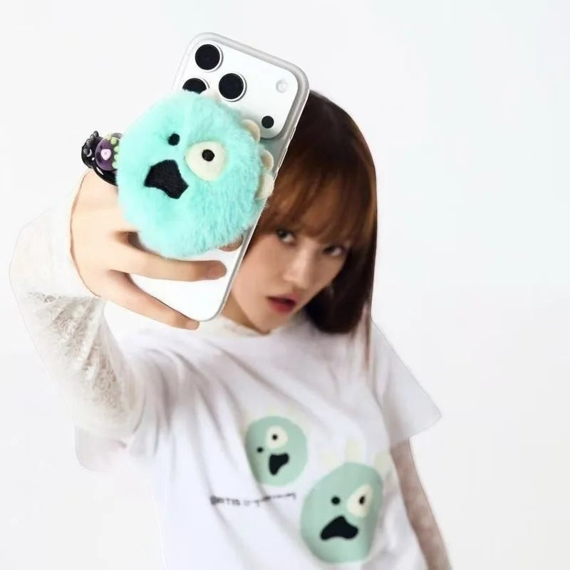 CORTIS Ball griptok held on the back of a phone during a mirror selfie