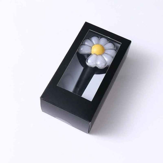 Lightstick Shop G-DRAGON Day-G Mini Lightstick Keychain, a compact, flower-shaped light with a yellow center and white petals, presented in a black box.