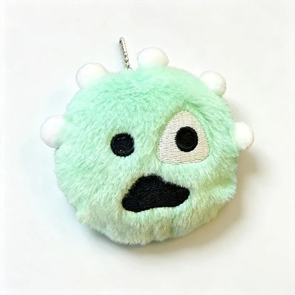 Green plush monster keychain pendant with embroidered face and white spikes