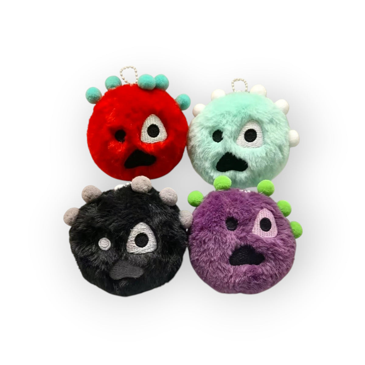 CORTIS Ball plush keychains in red, mint, black, and purple with embroidered monster faces