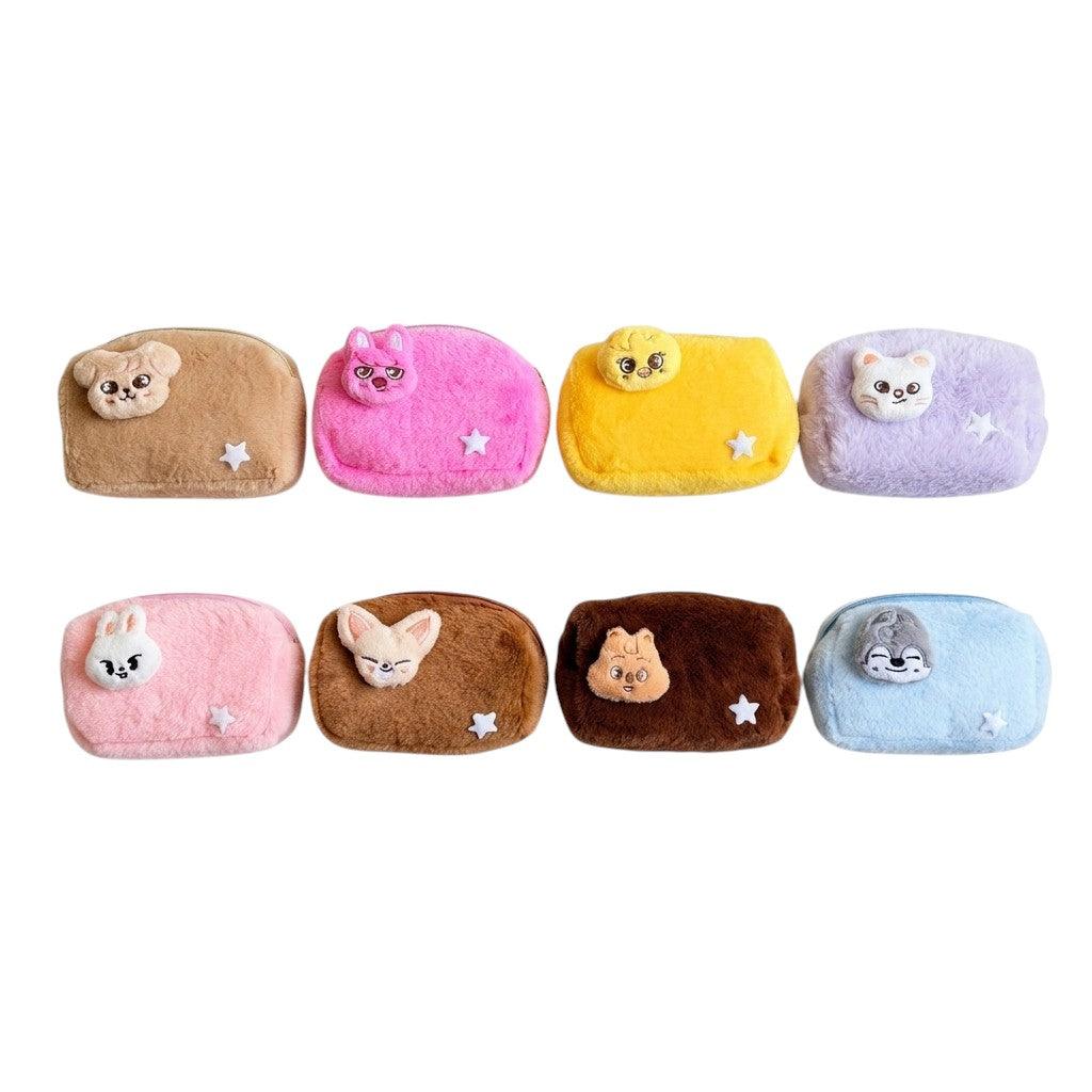 Lightstick Shop SKZOO plush character pouches in 8 colors: brown, pink, yellow, purple, light pink, dark brown, brown, and blue. Each pouch features a character face and a star.