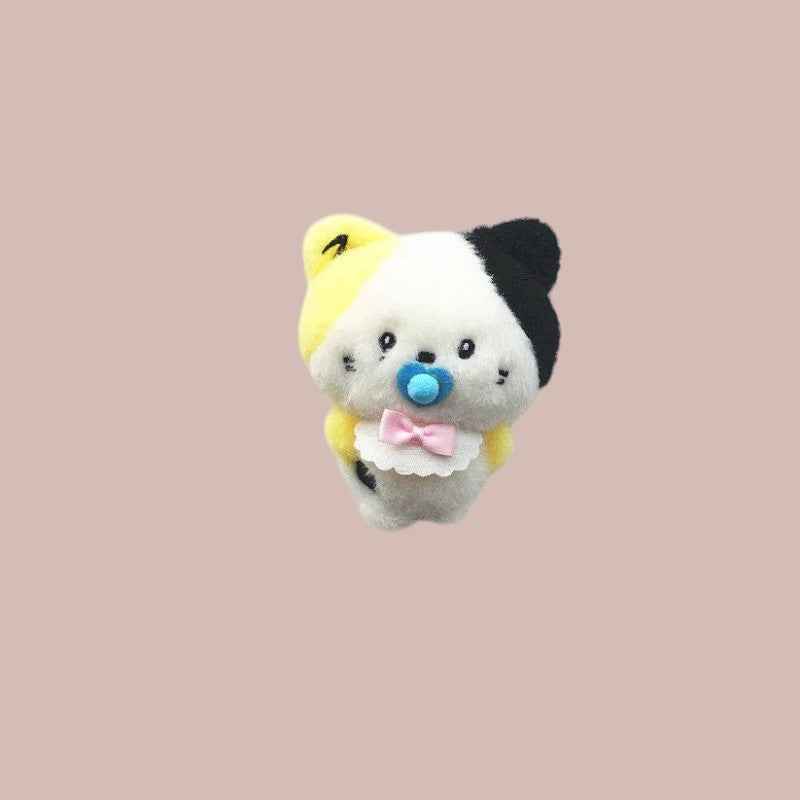 Lightstick Shop Zeroni plush mascot doll with yellow, white, and black fur, wearing a blue pacifier and pink bow bib.